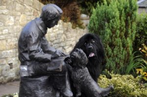 Photo Credit: Paddy the Newfoundland checks out the statue of Robert Louis Stevenson. Picture: Greg Macvea for The Scotsman. Robert Louis Stevenson was born on November 13, 1850.